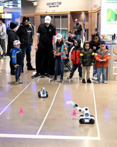 Children race RC robots